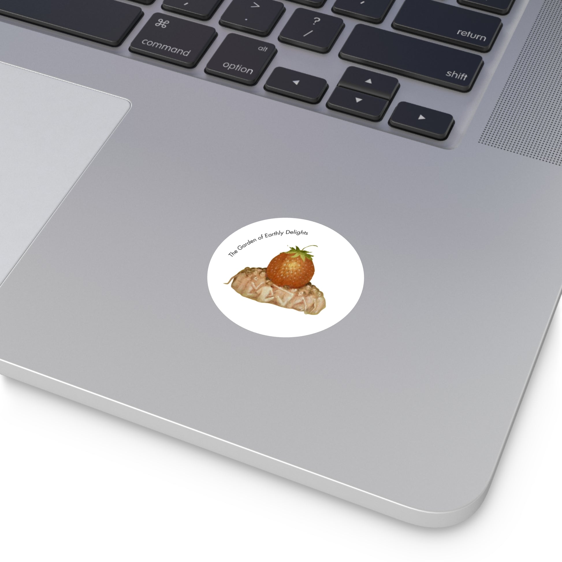 Image of round sticker on computer, with detail from Hieronymus Bosch's painting Garden of Earthly Delights.