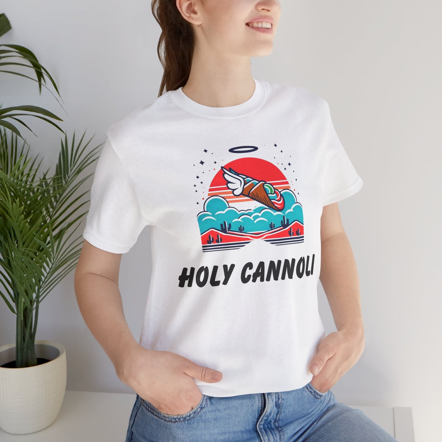Picture of t-shirt with AI-generated image of a cannoli with wings flying above a desert above the words "Holy Cannoli."