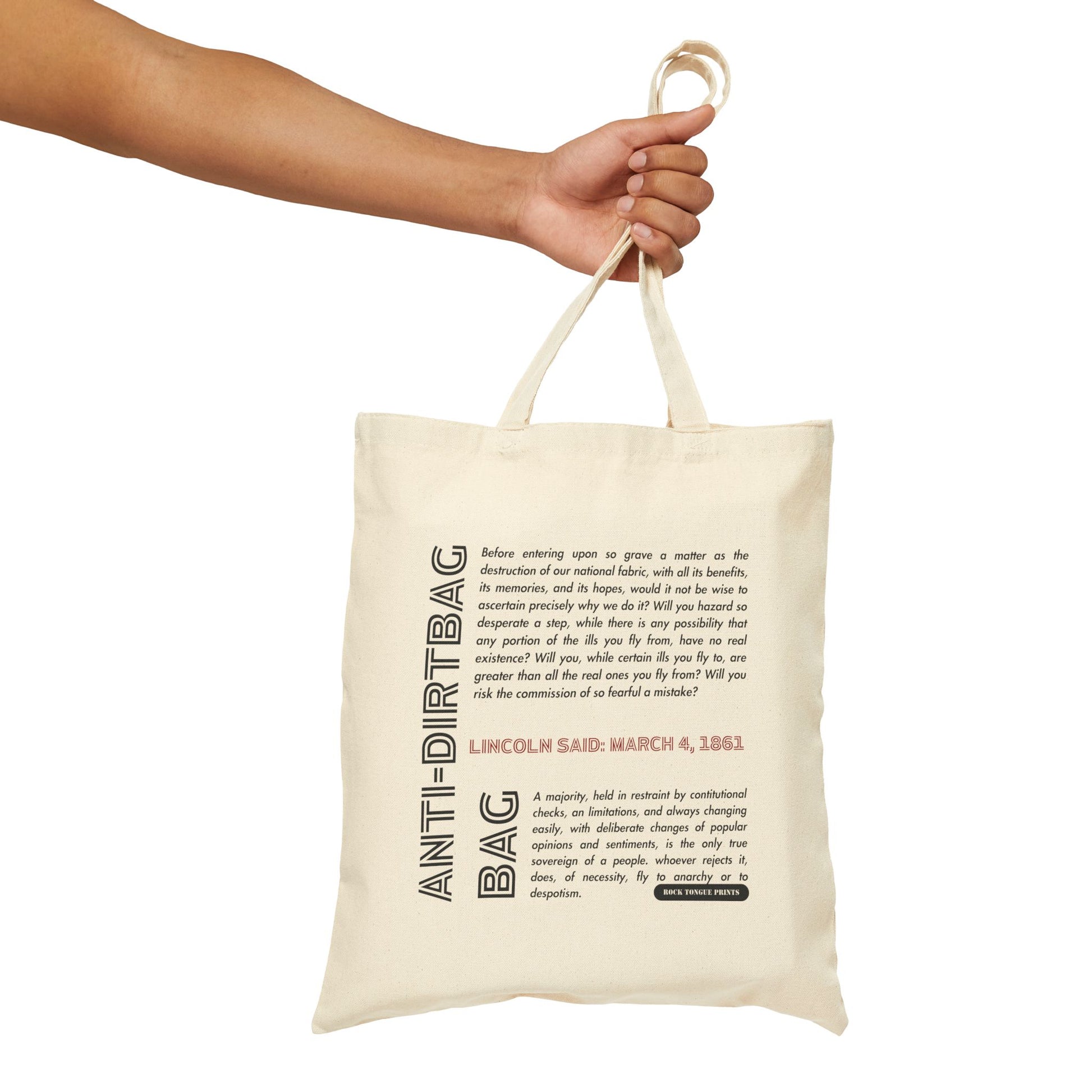 Picture of hand holding cotton canvas tote with large-text words "Anti-dirtbag bag" and smaller-text quote from Abraham Lincoln from March 4, 1861