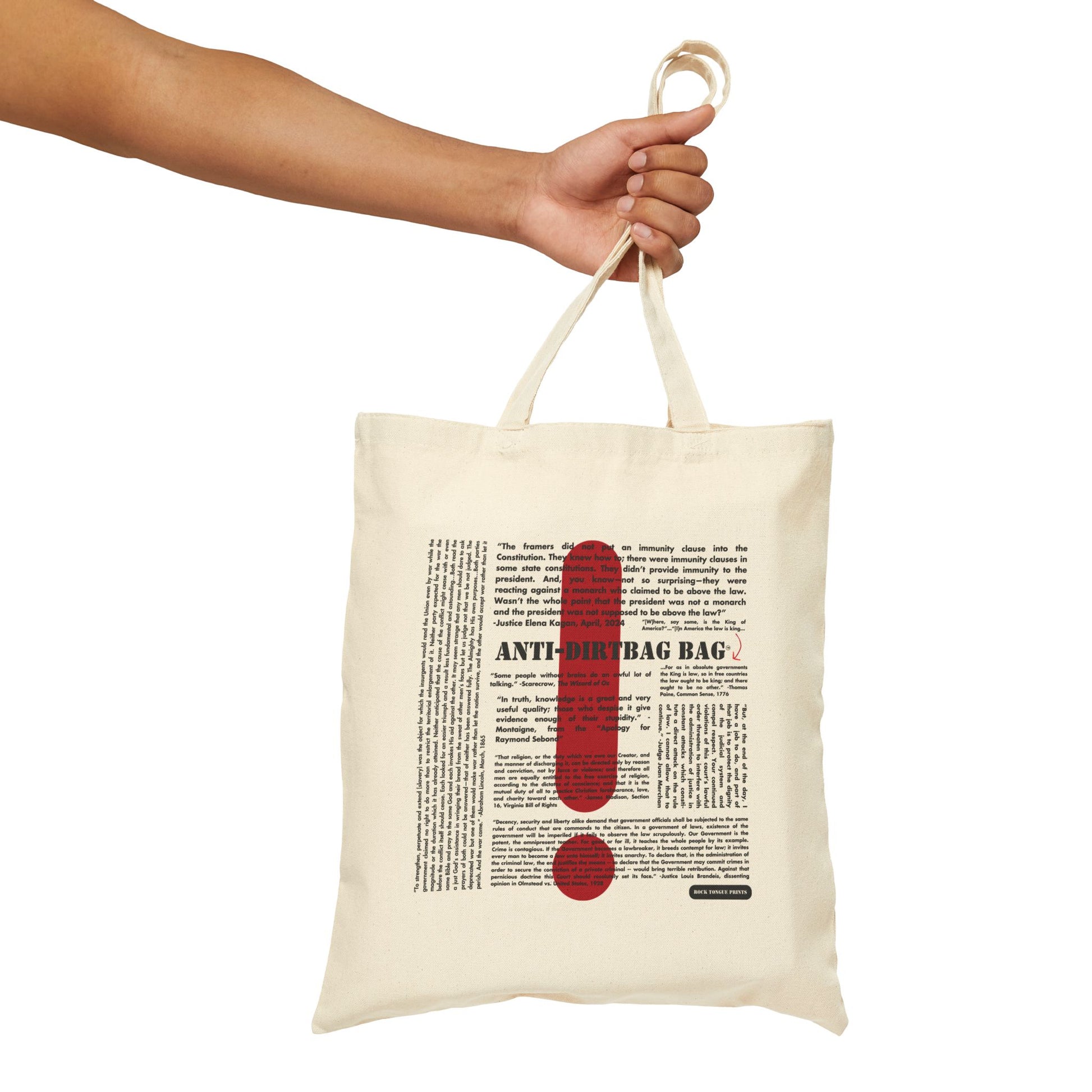 Picture of hand holding a cotton canvas tote with large-text words "Anti-Dirtbag Bag, " a large red exclamation point, and smaller-text, social justice oriented quotes.